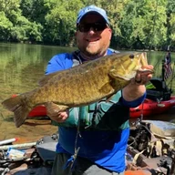 Aaron Finney holding a smallmouth bass